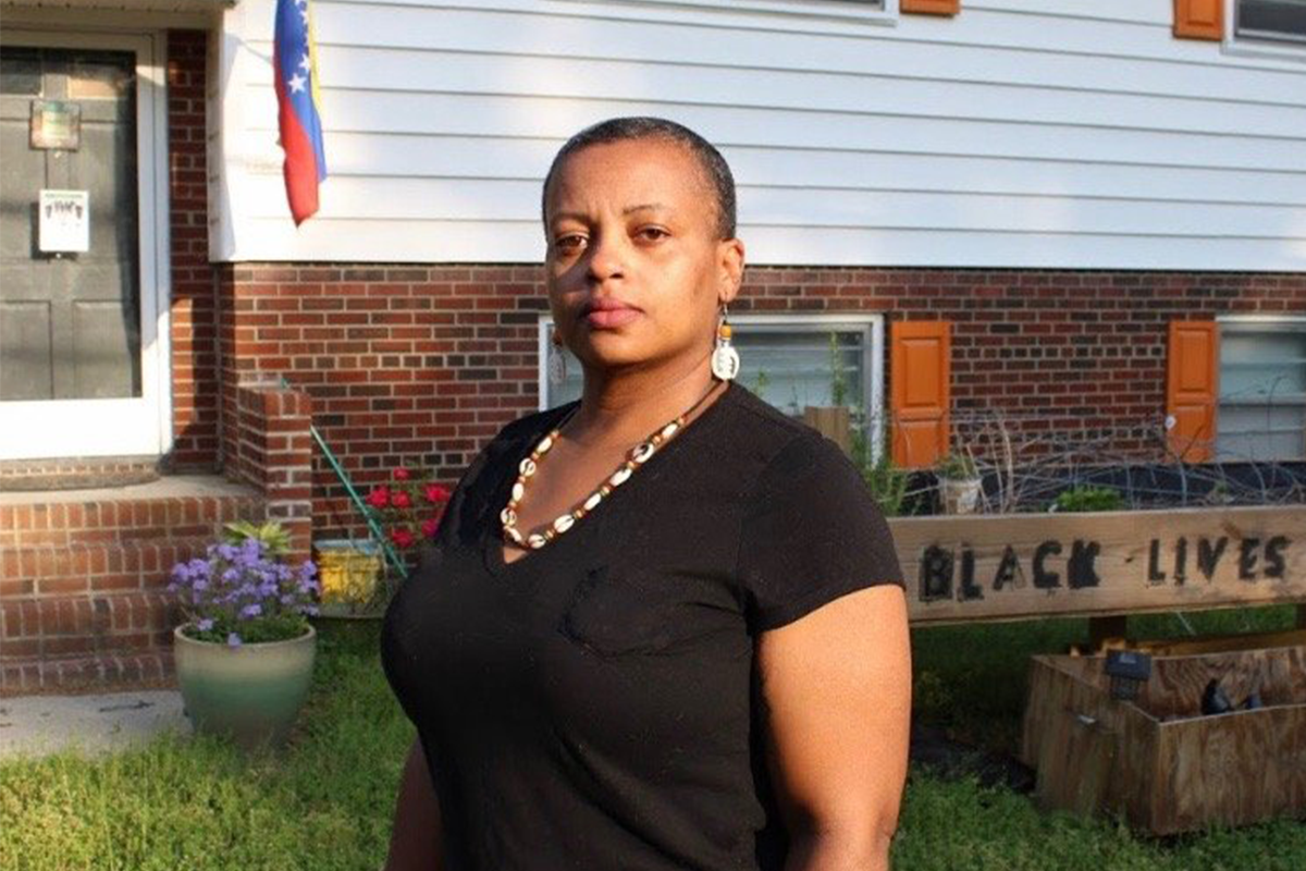 Mikisa Thompson in front of her house that was raided by garner pd for listening to Malcolm X